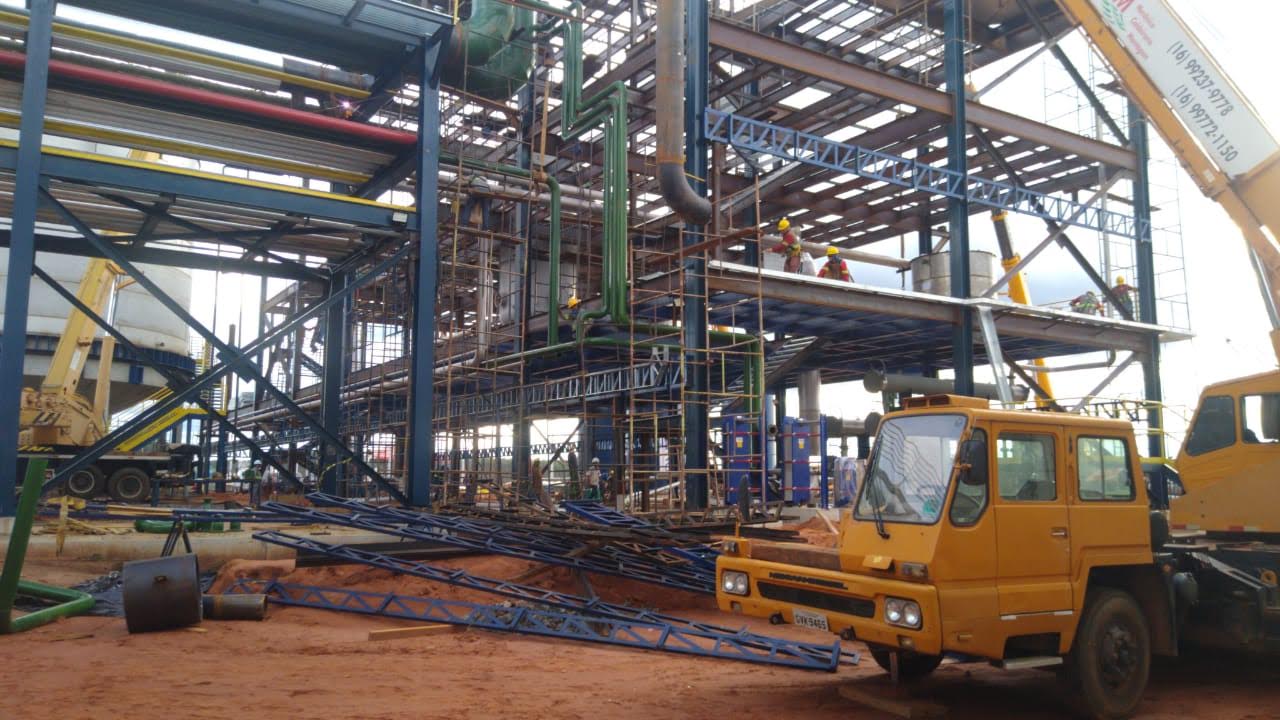 Obra industrial de grande porte com guindaste — montagem de planta complexa